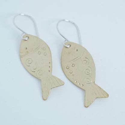 Fish-shaped earrings on a white background