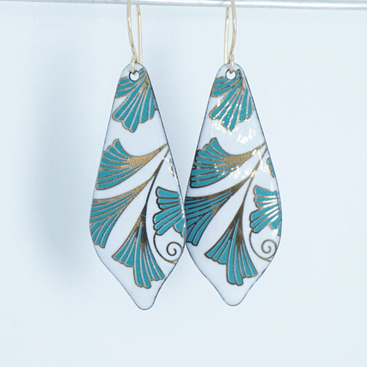 Teardrop-shaped earrings with green and gold leaf pattern on a white background