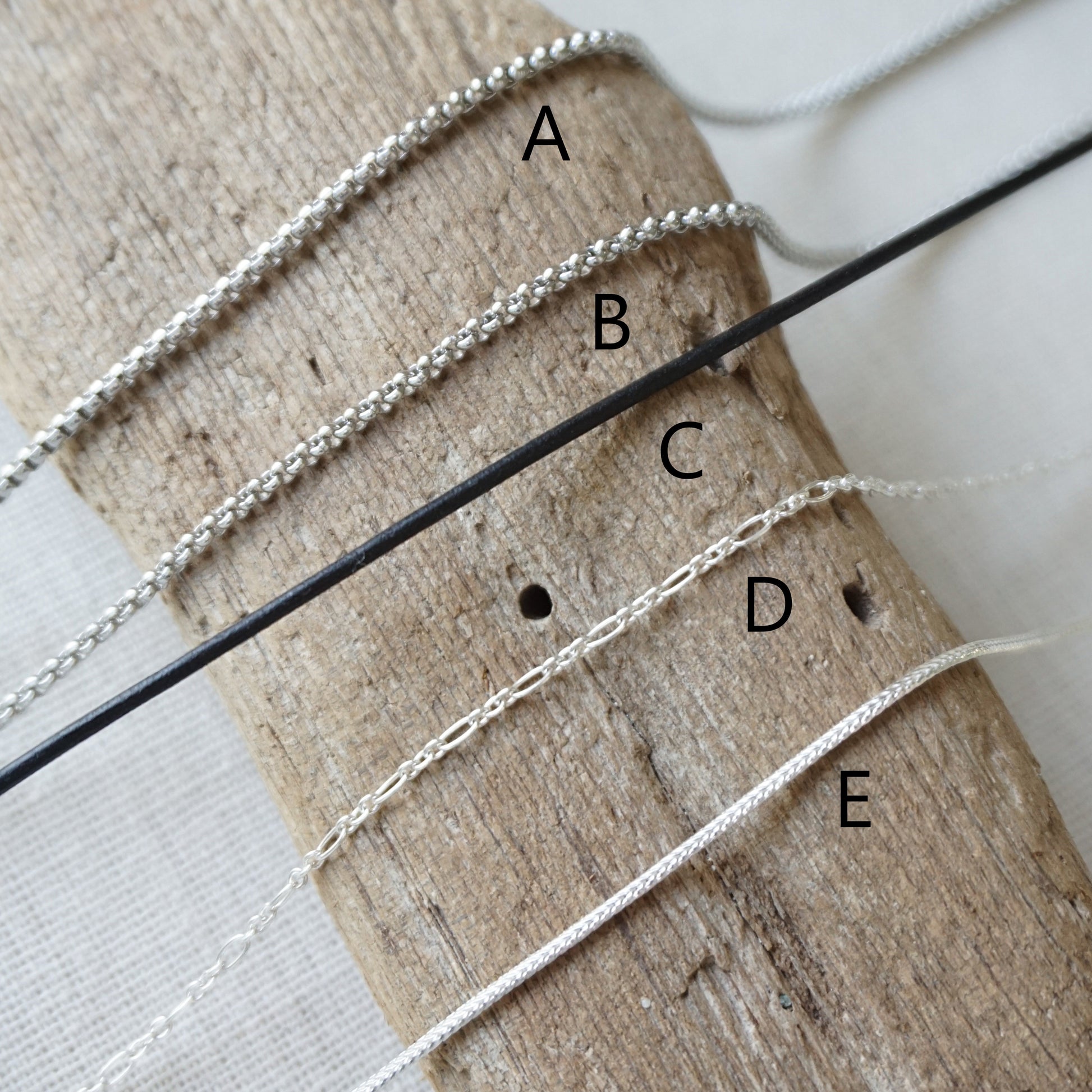 Five different chain options. Options include stainless, leather, and sterling chains